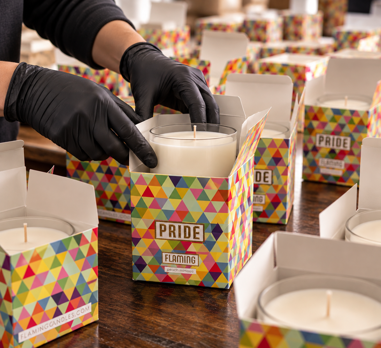 A team member hand-packing a candle into its gift box