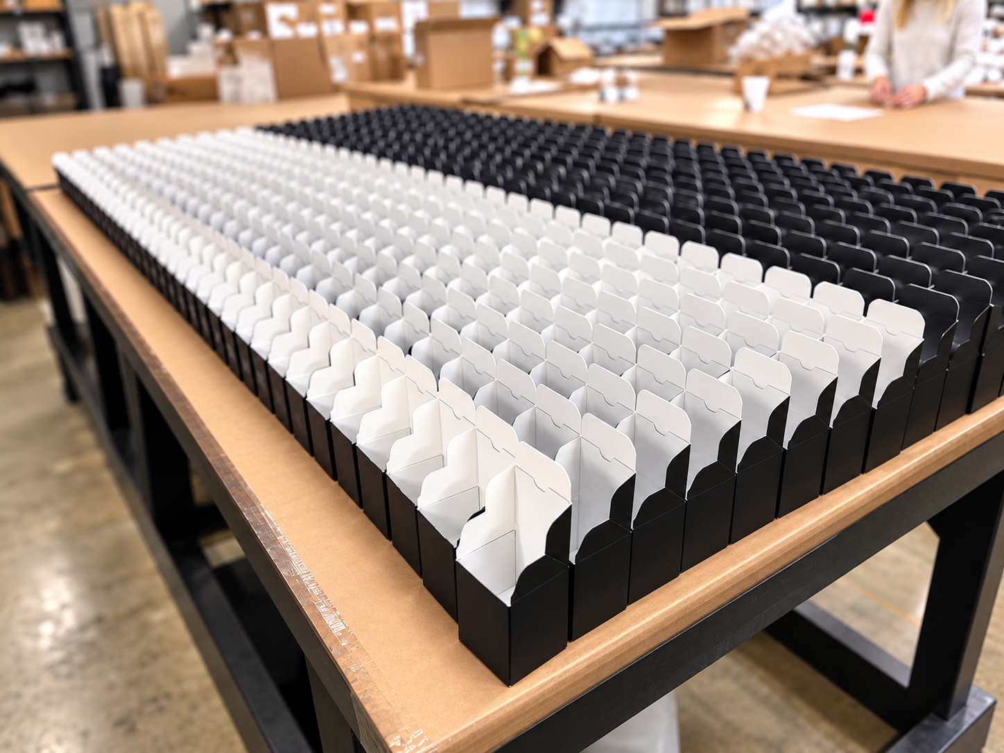 Gift boxes ready for candle packaging on the assembly table
